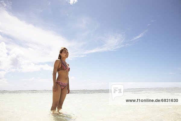 Young woman standing in water  Guam  USA