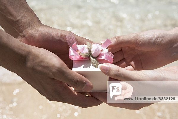 Young couple holding a gift together  Guam  USA