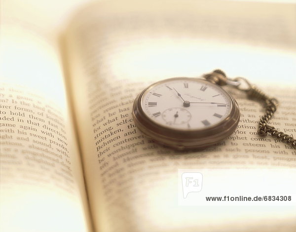 Pocket watch on book  close up