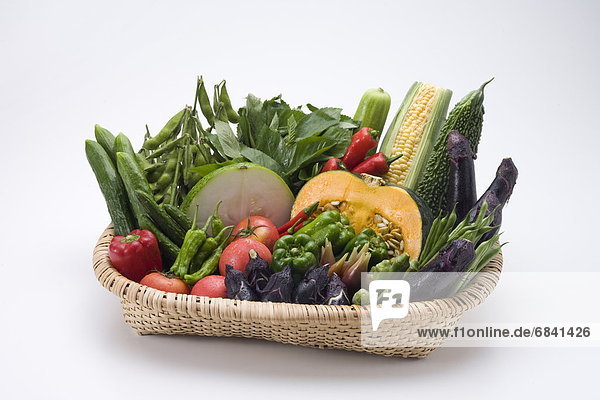 Assorted vegetables in basket  white background