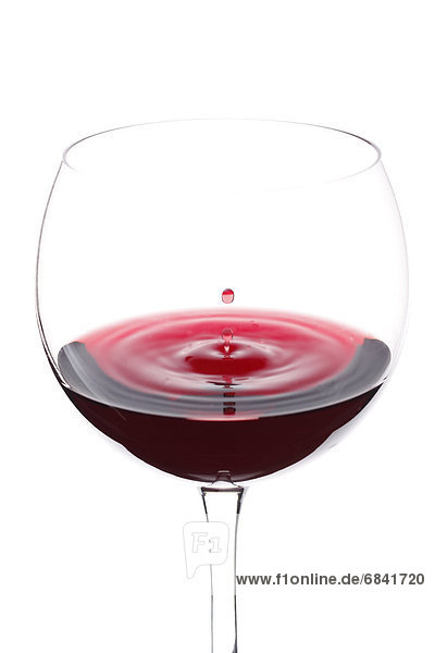 Red wine being poured into wineglass