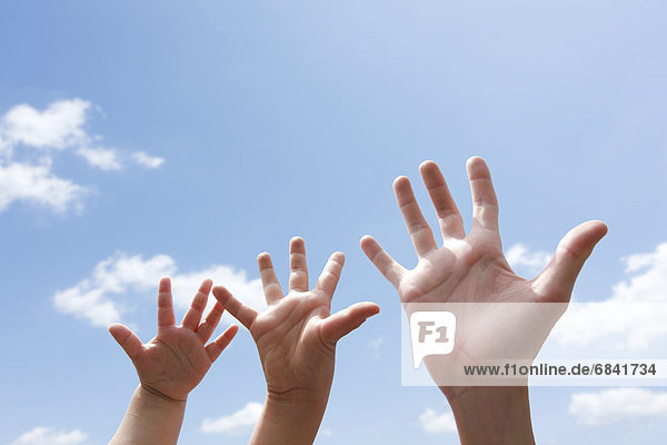 Three Hands Against Sky