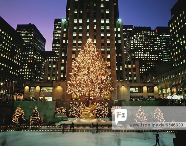 Ice skaters and a Christmas tree at Rockefeller Center. New York City  New York  USA