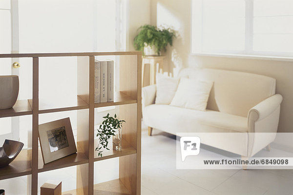 White sofa and shelf in sunny room