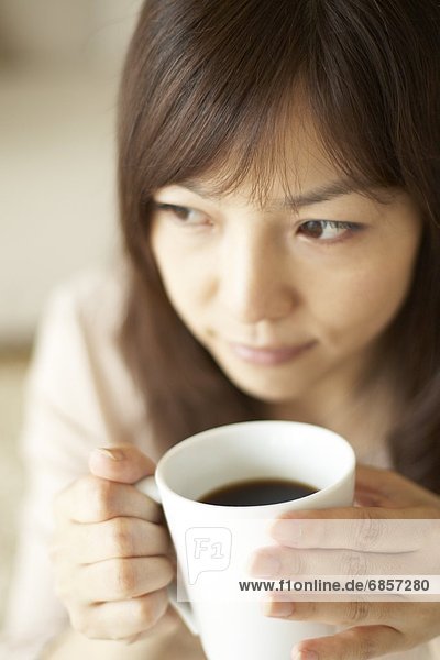 Young woman drinking a cup of coffee
