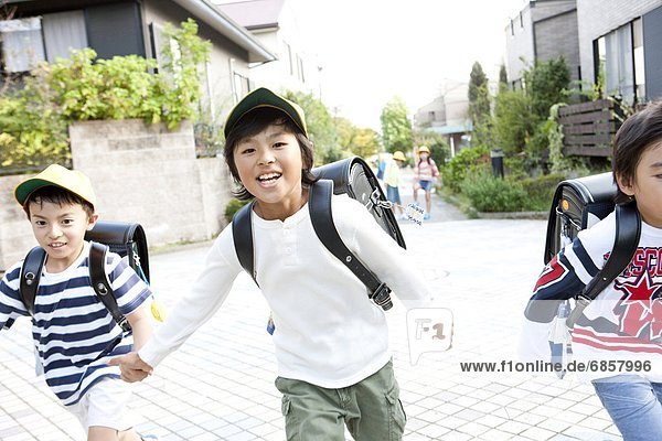 Elementary school students running to school