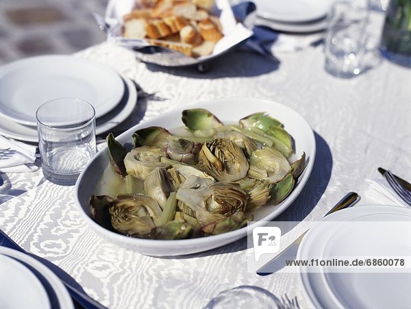 A bowl of artichokes on a table for lunch. Italy  Europe