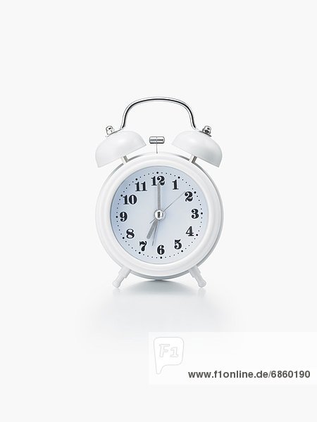 A White Alarm Clock on a White Background