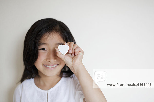 Girl Holding Love Heart in Front of her Eye