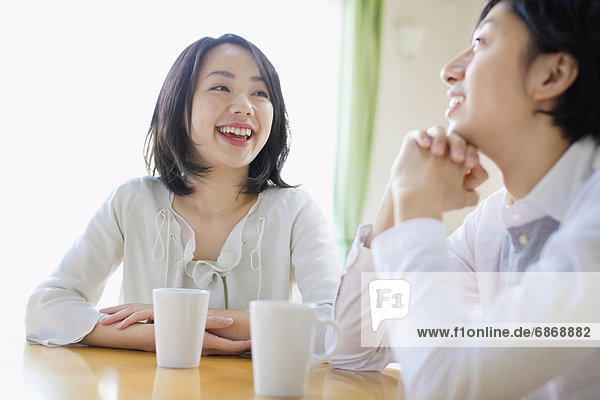 Young Couple Chatting Over Cup of Coffee