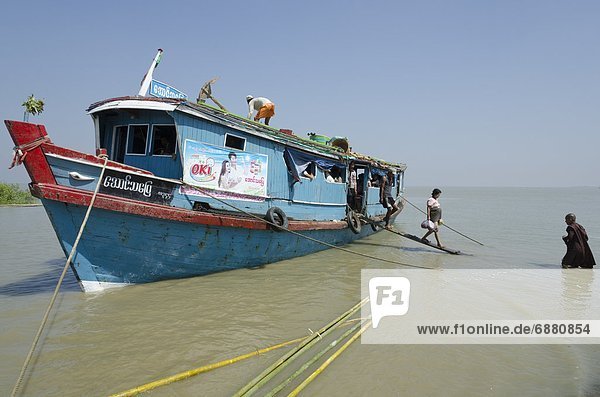 Passenger disembarking from a public boat at Lay Win Kwin village  Irrawaddy Delta  Myanmar (Burma)  Asia