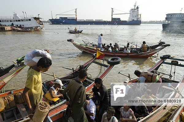 Passengers embarking on a small ferry boat across the river. Yangon harbour  Myanmar (Burma)  Asia