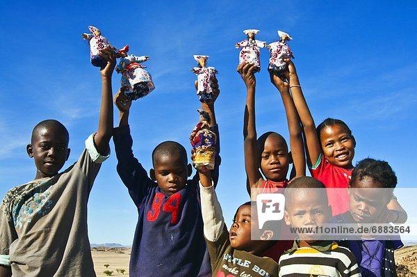 Herero children selling Herero dolls  Damaraland  Kunene Region  Namibia  Africa