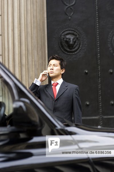 Businessman On The Phone Near Black Cab