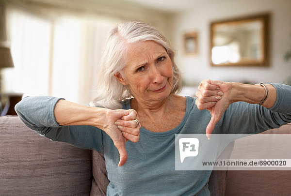 Senior woman with thumbs down