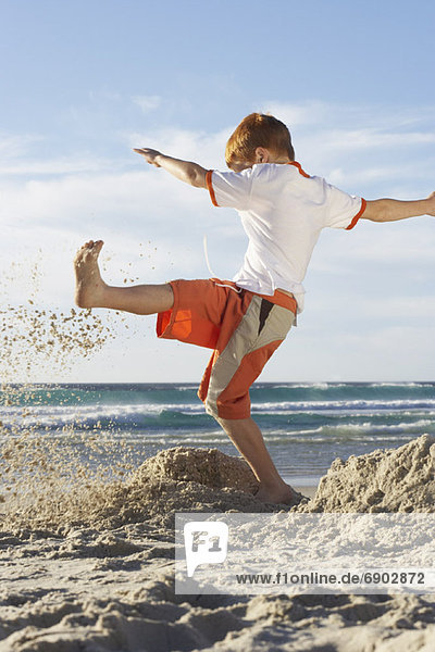 Boy Kicking Sandcastles