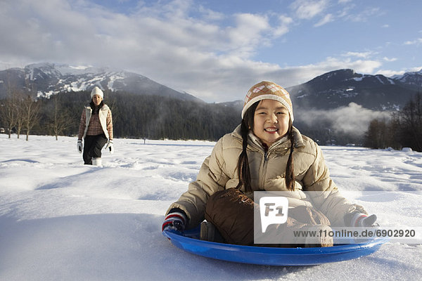 Mother and Daughter Sledding  Whistler  British Columbia  Canada