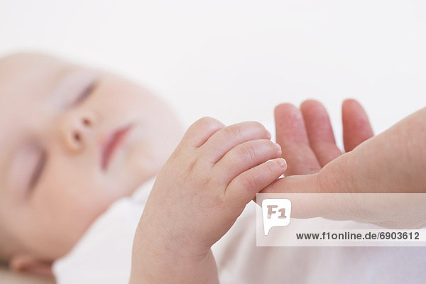 Baby Holding Adults Finger