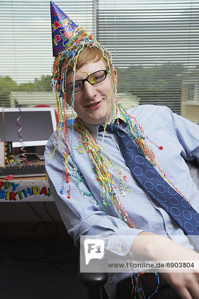Portrait of Office Worker with Birthday Decorations