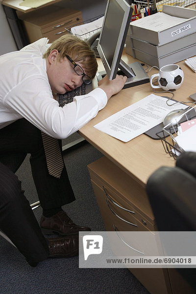 Businessman Asleep at Desk