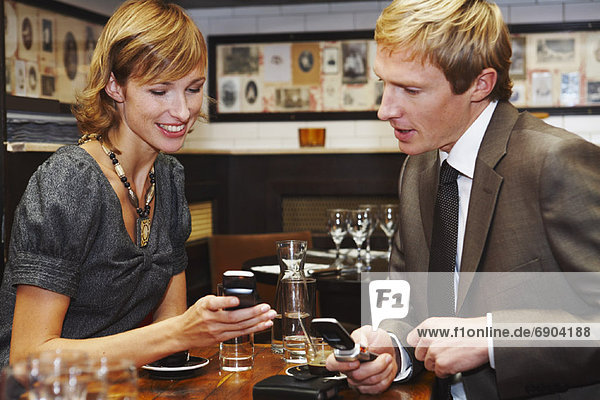 Couple with Cell Phones in Cafe