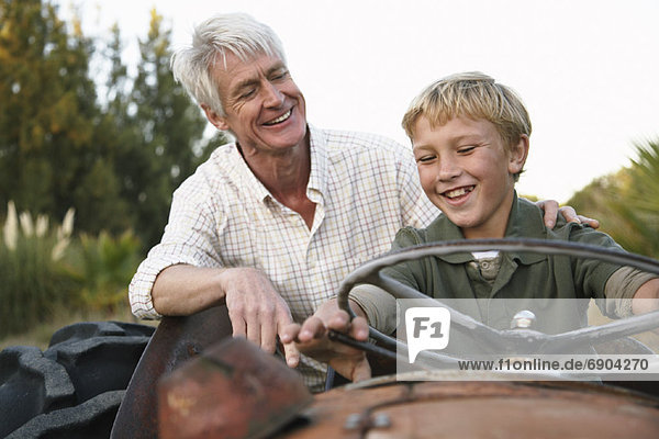 Grandfather and Grandson on Tractor