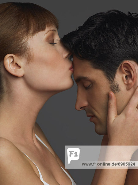 Woman Kissing Mans Forehead
