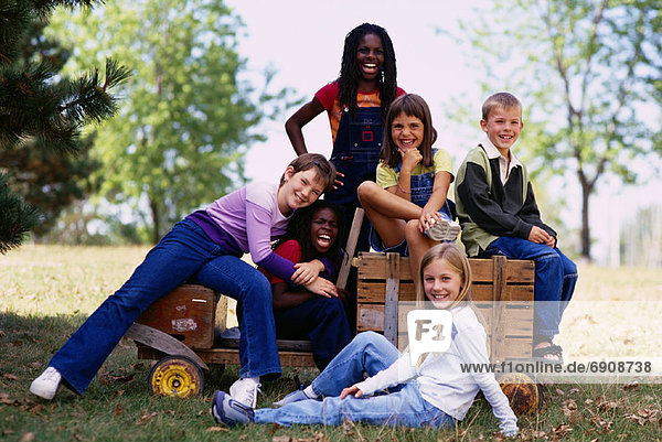 Group Portrait of Children with Soapbox Car Outdoors