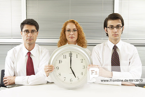 Portrait of Business People With Clock