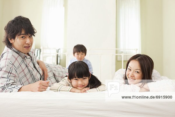Family of Four in Bedroom