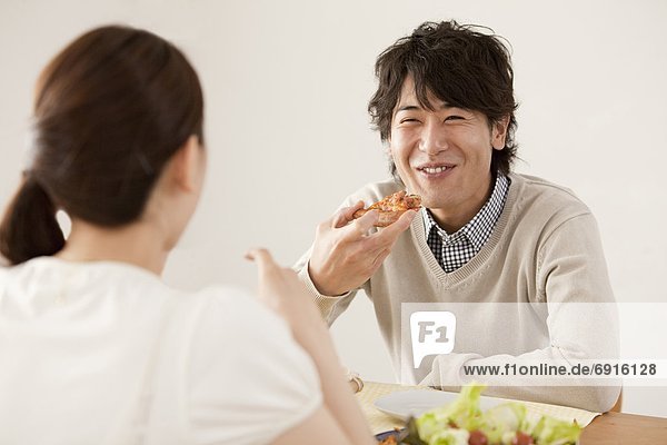 Young Couple Eating Pizza