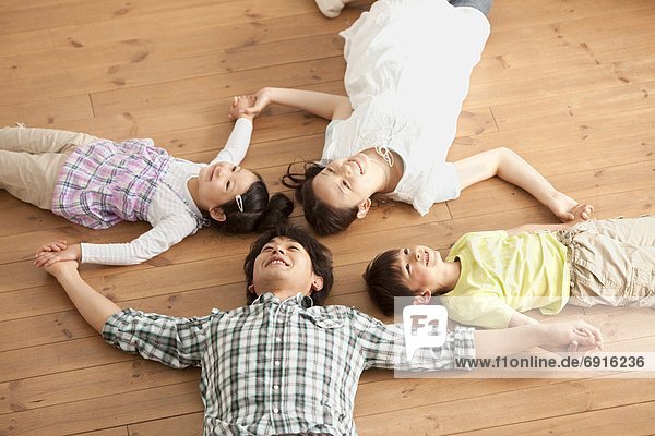 Family of Four Lying on Floor