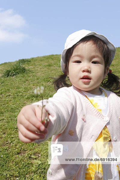 Baby Girl Giving Flower