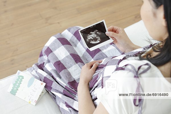Pregnant Woman Looking at Ultrasaound Scan