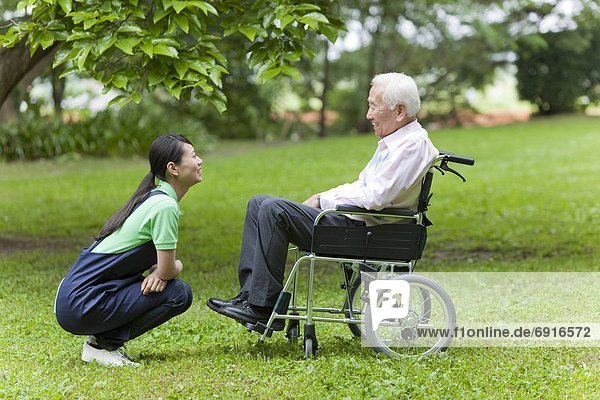 Social Worker with Senior Man on Wheelchair