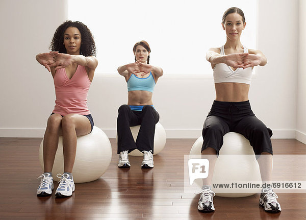 Women Sitting on Exercise Balls