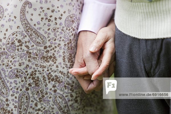Close Up of Senior Couple Holding Hands