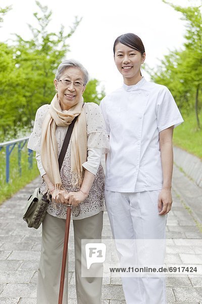 Healthcare worker with senior woman  Kanagawa Prefecture  Honshu  Japan
