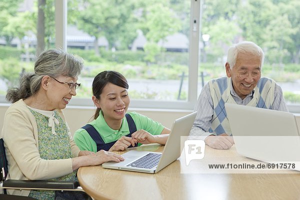 Senior people using laptop  Kanagawa Prefecture  Honshu  Japan