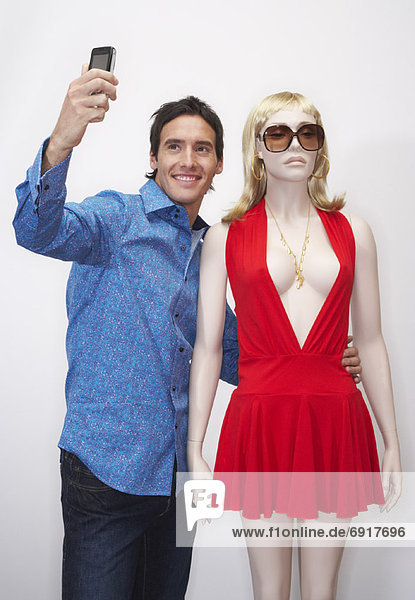 Man Taking Picture with Mannequin