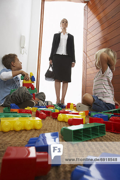 Mother Returning Home From Work Looking at Mess