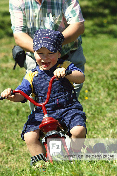 Boy Riding Tricycle