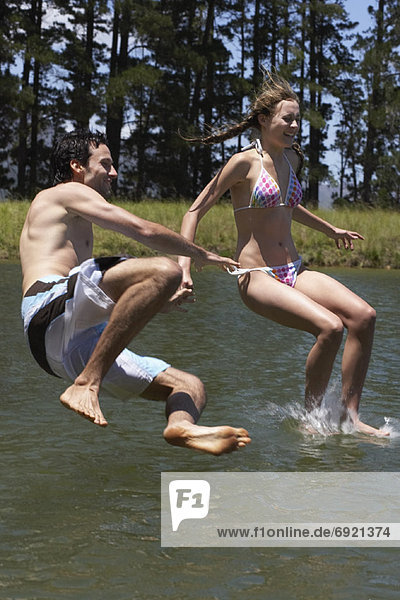 Couple Jumping into Water