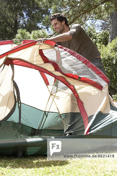 Man Putting up Tent