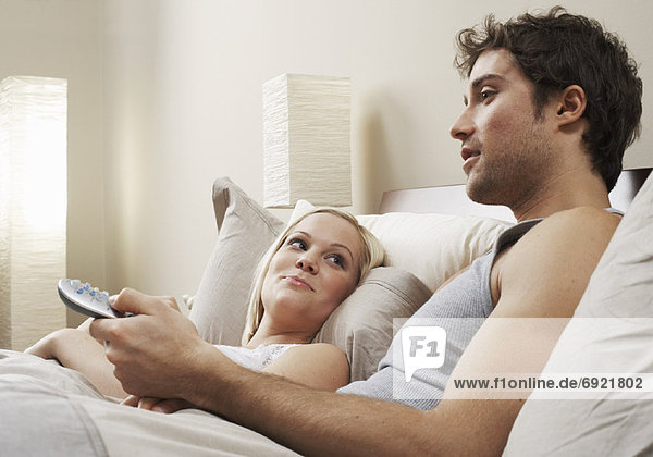 Couple Watching Television in Bed