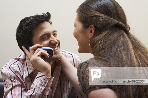 Couple Using Cellular Phone