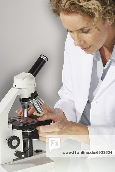 Doctor Looking Into Microscope