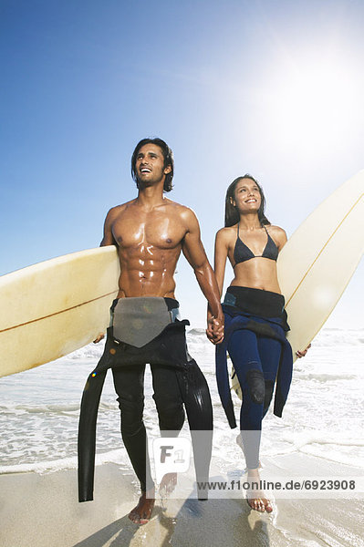Couple with Surfboards at Beach