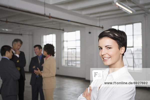 Portrait of Businesswoman with other Business People in Background