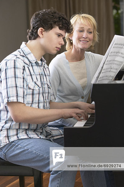 Woman and Boy Playing Piano